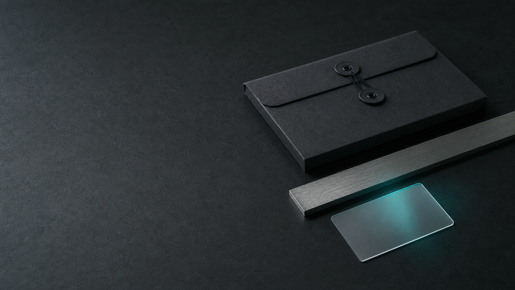 Unbranded paper sleeve and steel reference edge on a graphite desk